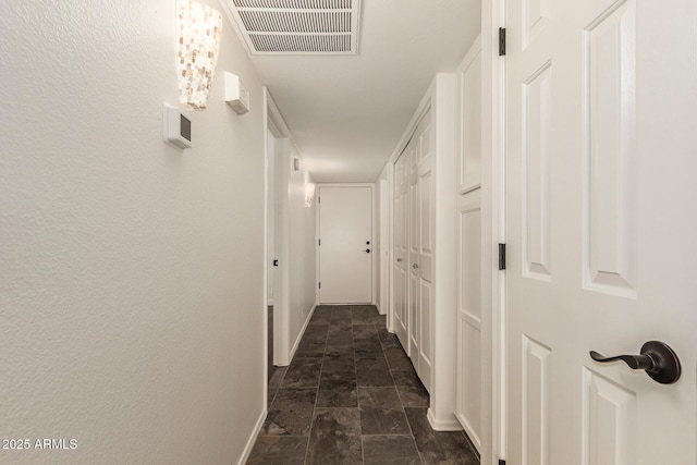 19812 N 90th Dr, Peoria, AZ 85382 - corridor featuring baseboards, visible vents, and stone finish floor