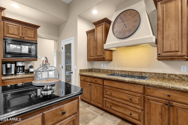 kitchen featuring electric cooktop, custom range hood, and black microwave