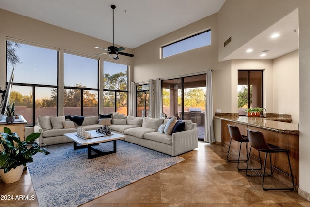 sunroom with ceiling fan and sink