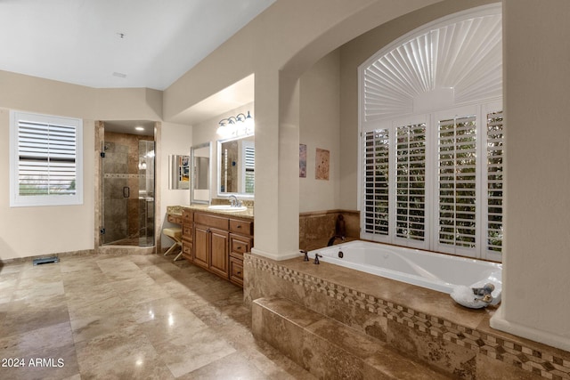 bathroom with vanity and independent shower and bath