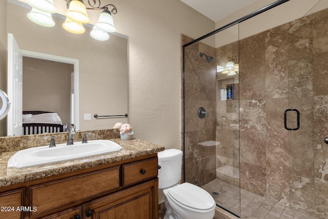 bathroom with vanity, toilet, and a shower with shower door