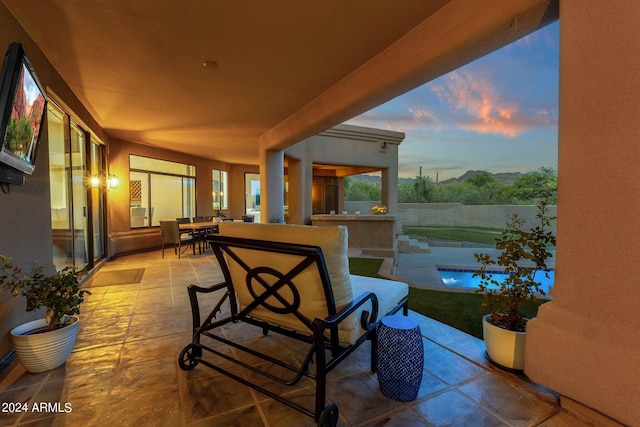 patio terrace at dusk featuring an outdoor bar