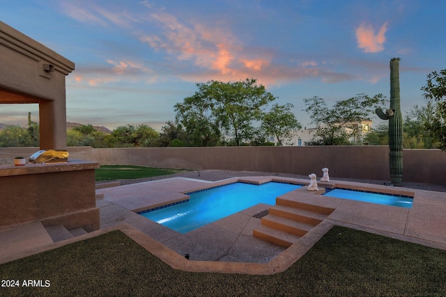 view of pool at dusk