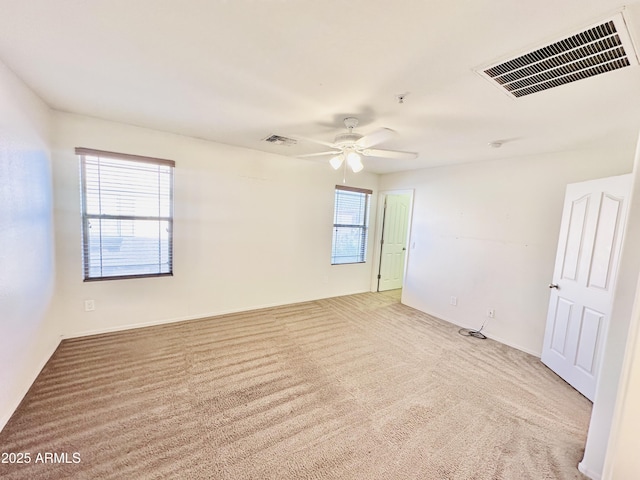 carpeted empty room featuring ceiling fan