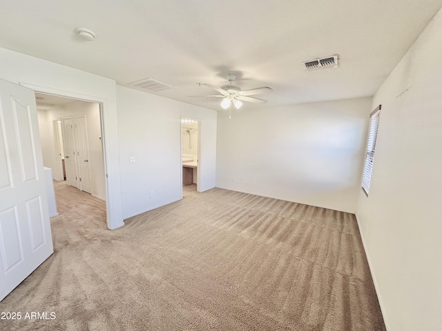 empty room featuring light carpet and ceiling fan