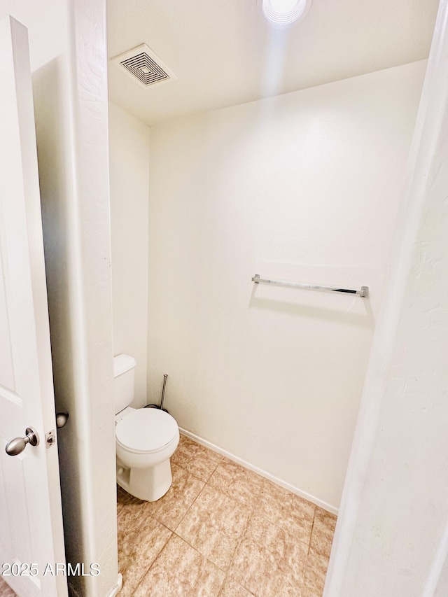 bathroom with tile patterned floors and toilet