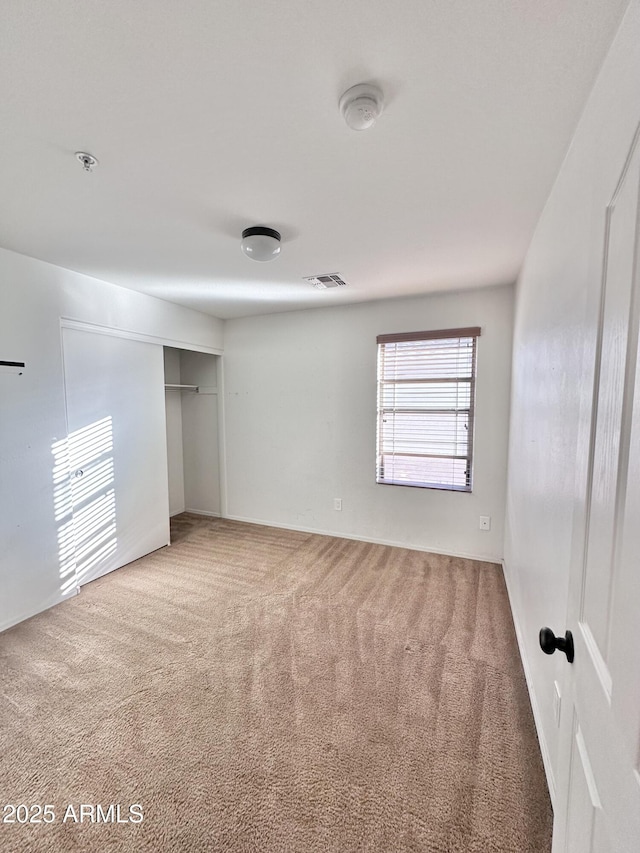 unfurnished bedroom with a closet and carpet