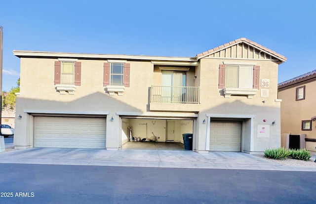 view of property featuring a balcony and a garage