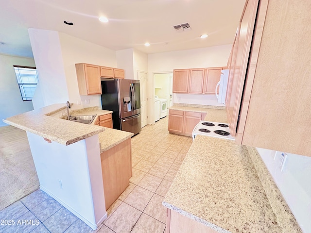 kitchen featuring kitchen peninsula, stainless steel fridge with ice dispenser, sink, and light brown cabinetry