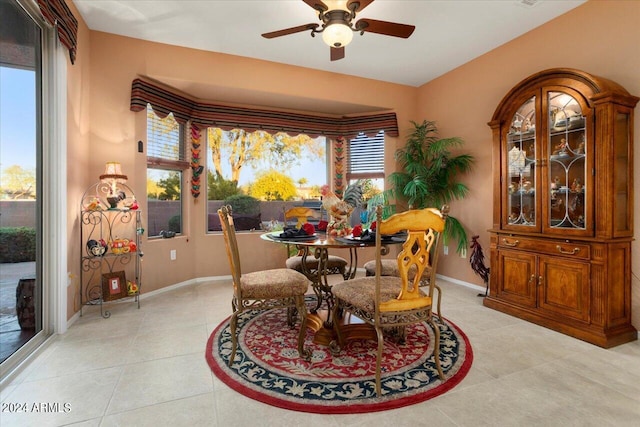 dining space featuring ceiling fan and light tile patterned floors