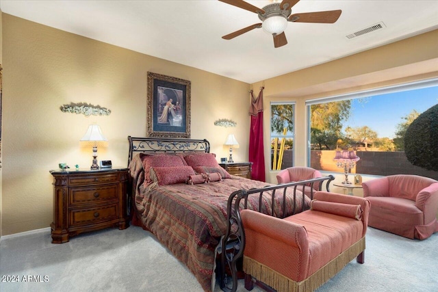 bedroom with ceiling fan and light colored carpet