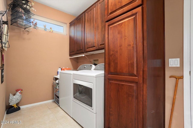 washroom with washing machine and dryer and cabinets