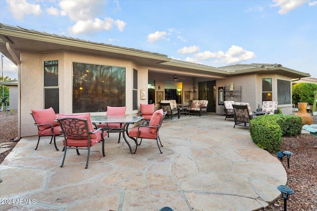 view of patio / terrace with an outdoor living space and ceiling fan