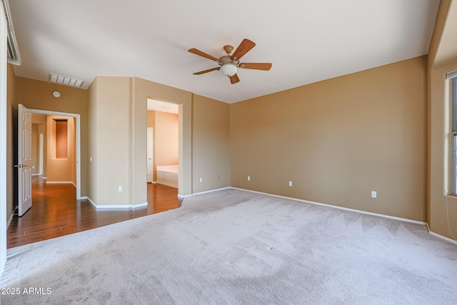 carpeted spare room featuring ceiling fan