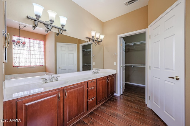 bathroom with vanity, hardwood / wood-style floors, and a chandelier