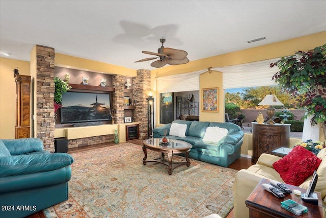 living room with hardwood / wood-style flooring and ceiling fan