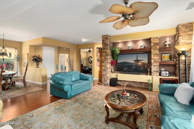 living room featuring wood-type flooring and ceiling fan