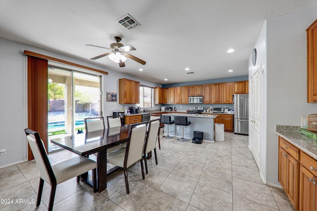 dining room featuring ceiling fan and light tile patterned floors