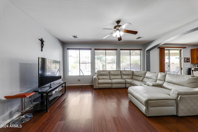 living room featuring ceiling fan and dark hardwood / wood-style flooring