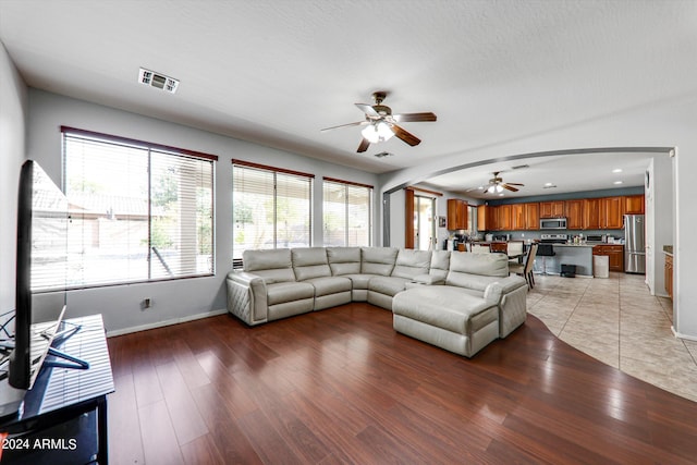 living room featuring ceiling fan and light hardwood / wood-style flooring