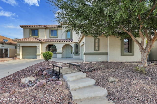 mediterranean / spanish-style house with a garage and a porch