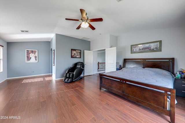 bedroom featuring ceiling fan, vaulted ceiling, and hardwood / wood-style floors