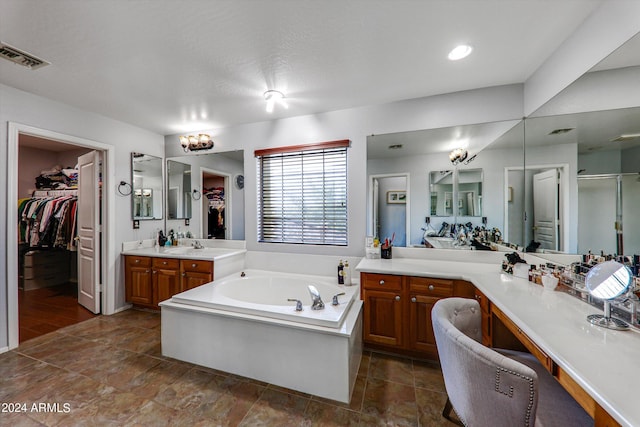 bathroom with shower with separate bathtub and vanity