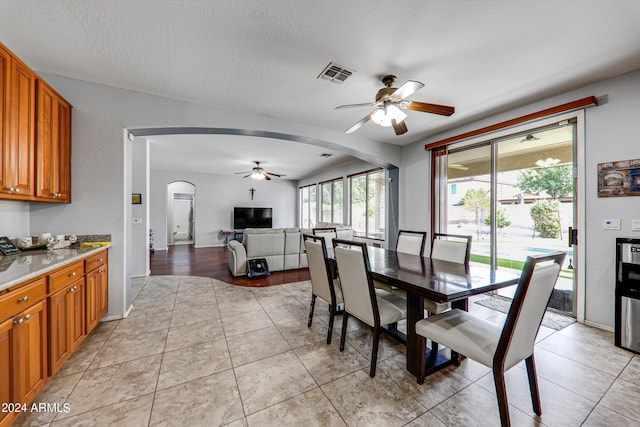 tiled dining space featuring ceiling fan and a textured ceiling