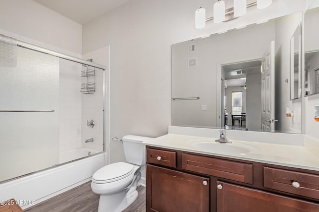 1100 N Priest Dr Unit 2145, Chandler, AZ 85226 - bathroom featuring visible vents, bath / shower combo with glass door, toilet, wood finished floors, and vanity