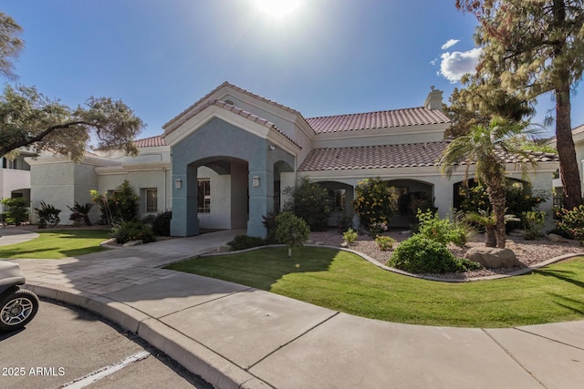 1100 N Priest Dr Unit 2145, Chandler, AZ 85226 - mediterranean / spanish house with a tiled roof, a front lawn, stucco siding, and a chimney