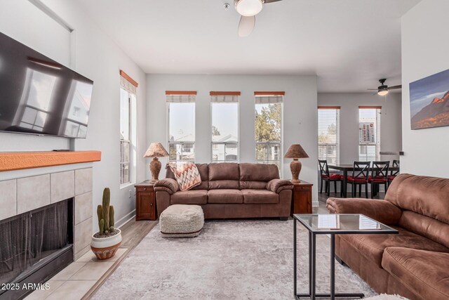 1100 N Priest Dr Unit 2145, Chandler, AZ 85226 - living area featuring baseboards, light wood-type flooring, a tiled fireplace, and ceiling fan