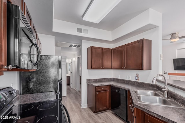1100 N Priest Dr Unit 2145, Chandler, AZ 85226 - kitchen with a sink, light wood-style flooring, dark countertops, visible vents, and black appliances