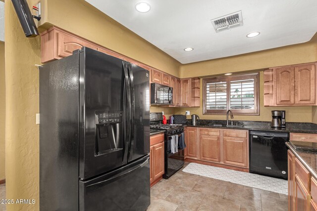 kitchen with open shelves, visible vents, a sink, dark stone countertops, and black appliances