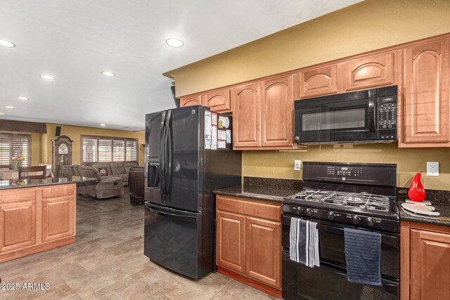 kitchen with open floor plan, black appliances, dark stone counters, and recessed lighting