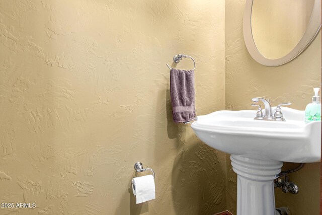 bathroom with a textured wall