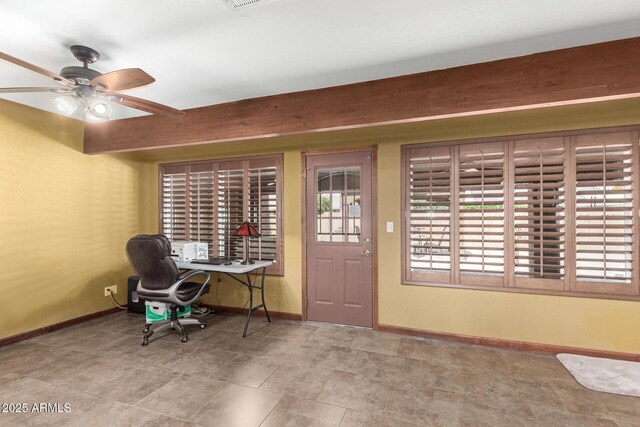 interior space with baseboards and a ceiling fan