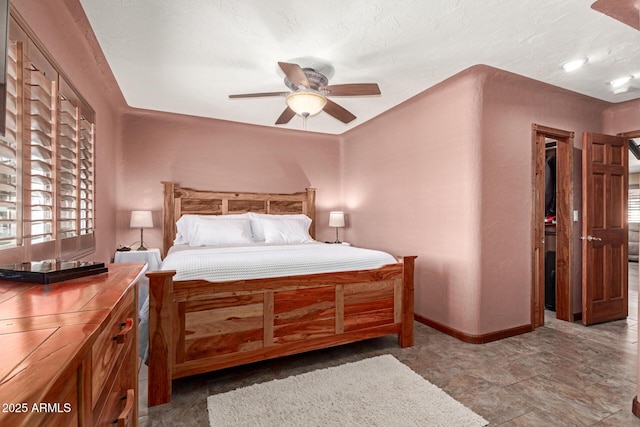 bedroom featuring ceiling fan and baseboards