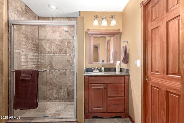 bathroom featuring a shower stall and vanity