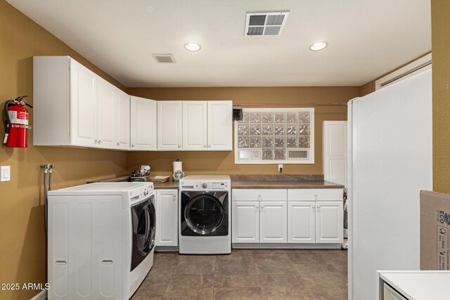 clothes washing area with recessed lighting, cabinet space, visible vents, and washer and dryer