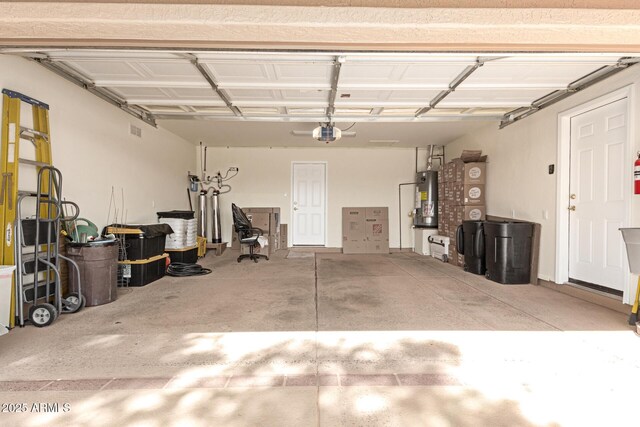 garage with water heater and a garage door opener