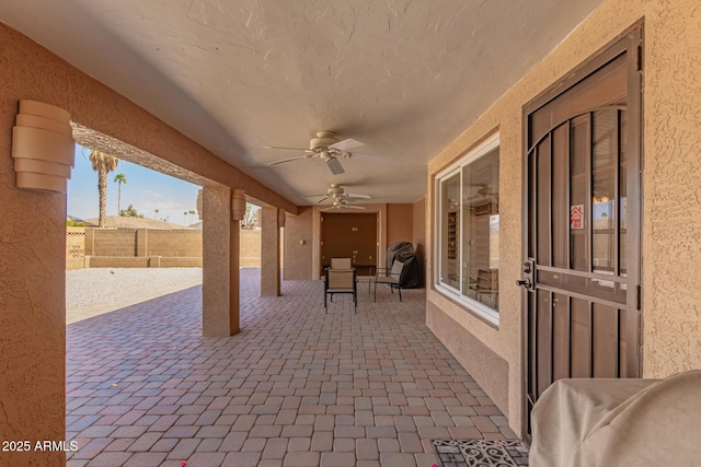 view of patio featuring fence and a ceiling fan