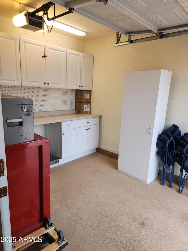 garage with baseboards, a workshop area, and a garage door opener