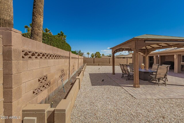 view of yard with a patio area, a fenced backyard, and outdoor dining area