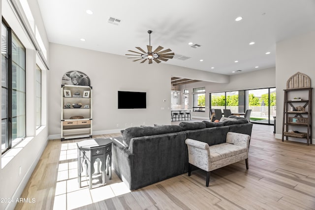 living room featuring ceiling fan and light hardwood / wood-style flooring