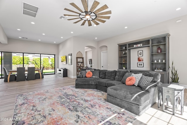 living room featuring ceiling fan and light wood-type flooring