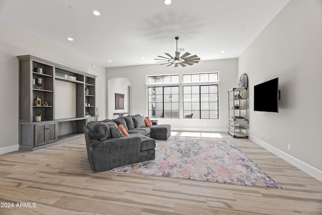 living room featuring ceiling fan and light hardwood / wood-style flooring