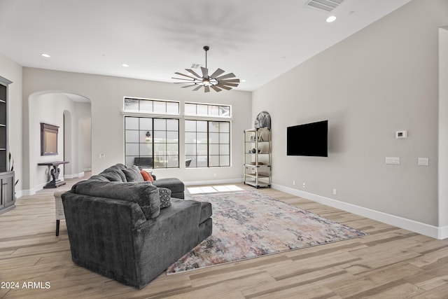 living room with light wood-type flooring and ceiling fan