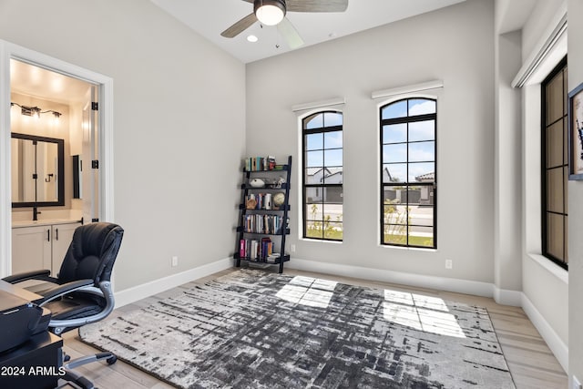 office area with ceiling fan and light hardwood / wood-style floors