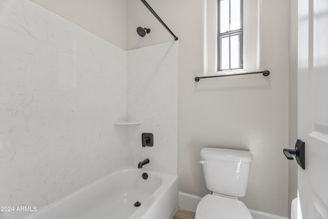 bathroom featuring toilet and tub / shower combination