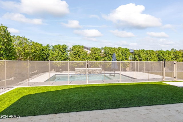 view of pool featuring a lawn